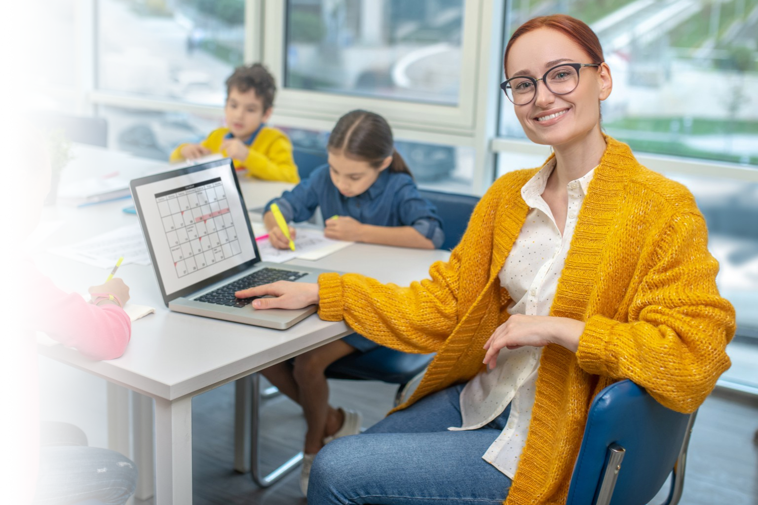 Teacher using digital tools to assess student learning and track progress in class